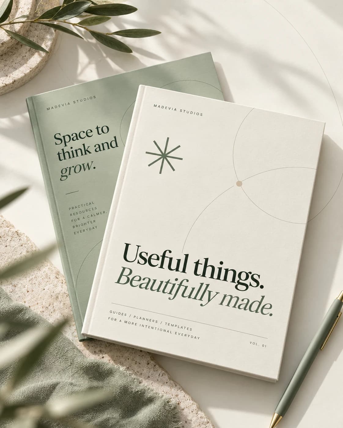 Madevia Studios stationery covers in ivory and sage, with an olive branch and a green pen